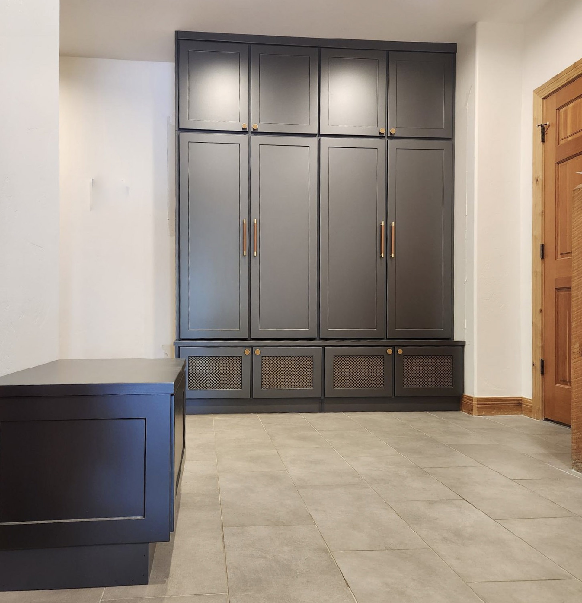 Bright minimalist white walk-in with black hardware